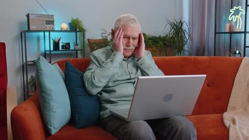 Senior Man Using Laptop at Home