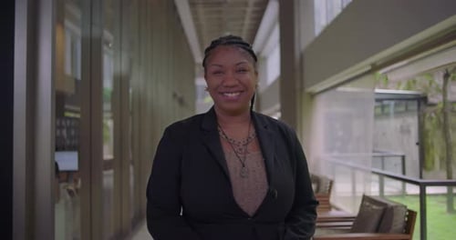 Confident Professional Woman Smiling in Modern Office
