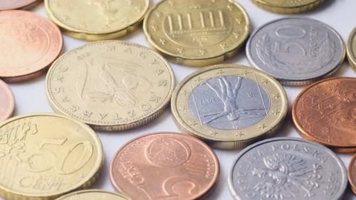Various Euro Coins Cents Rotate on the Table in Slow Motion