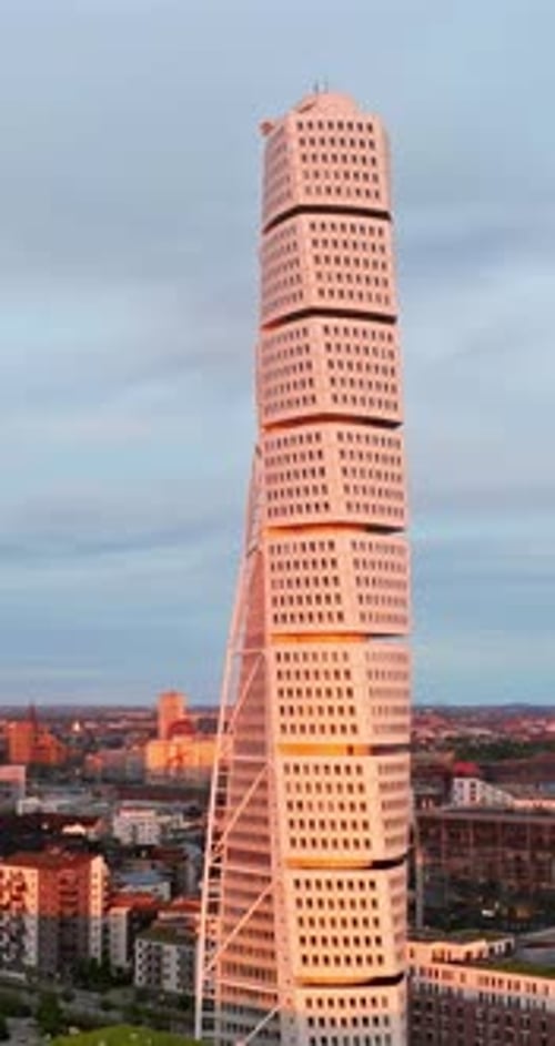 Aerial drone view of Turning Torso residential skyscraper in Malmo, Sweden at sunset. Vertical