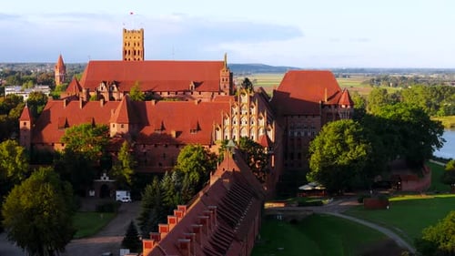 Château de l'Ordre Teutonique à Malbork au bord de la rivière Nogat au coucher du soleil, Pologne
