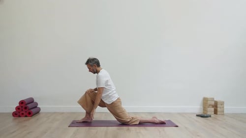 Adult Practices Yoga Poses on Yoga Mat