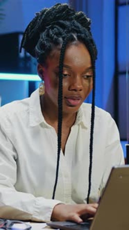 Overtime Work Concept Woman Office Manager in White Blouse Typing on Laptop Keyboard in Workroom