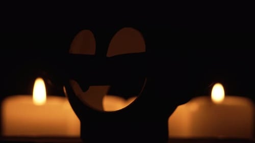 Rotating Jack-O-Lantern with Candles in Dark Night