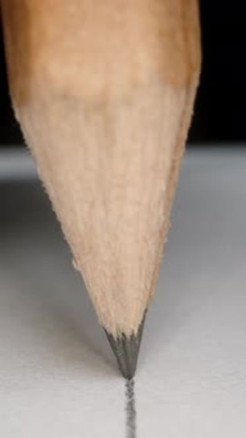Pencil Draws Straight Line on Paper Close Up