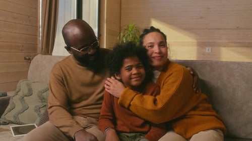 Portrait of Happy Family Sitting on Sofa