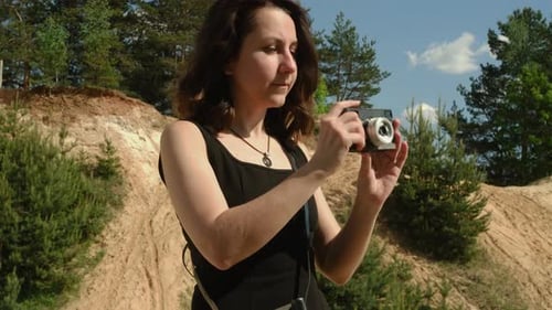 Young Woman Taking Pictures in Rural Area