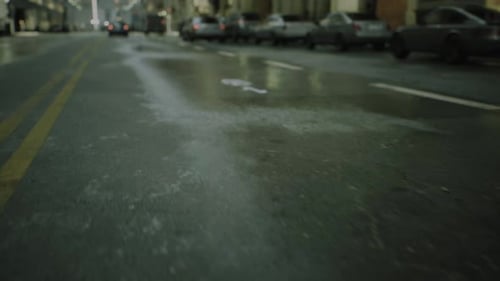 Closeup Cinematic POV Shot of Wet Asphalt in the Morning After Rain on Street Road