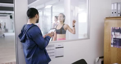 4k video footage of a young man and woman using a digital tablet in an office at the gym