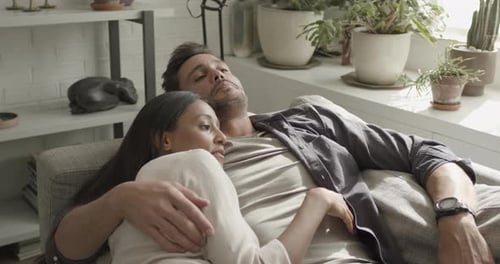 Couple Relaxing Together on Couch in Living Room