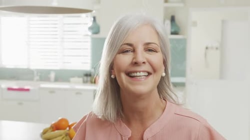 Joyful Woman Laughing in Her Modern Kitchen