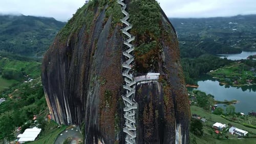 Close Aerial drone shot of long stairs to the top of El Penon de Guatape near Medellin, Colombia. Bi