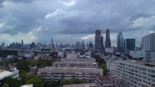 buildings of the suburb in the background cloudy sky line of the city. Breathtaking aerial view flig