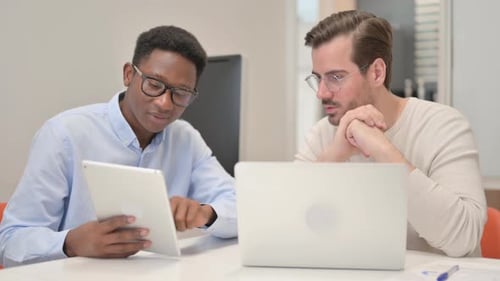 Office Colleagues Working with a Tablet and Laptop