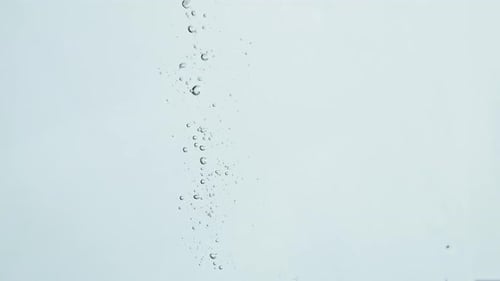 Closeup Lime Dropping Liquid in Light Background