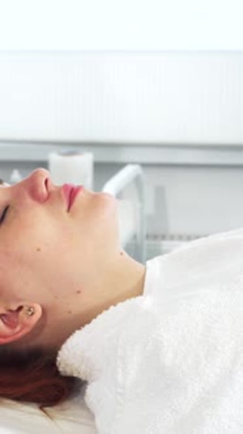 Woman Receiving Facial Treatment in Spa