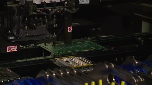 COMPUTER CHIP BEING BUILT BY MACHINE