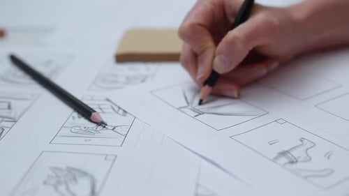 Hands draw a storyboard for the film. Pre-production of the movie.