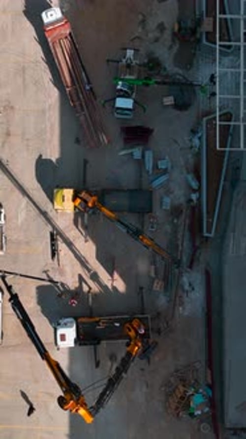 Aerial View of Cranes Rotating at Construction Site