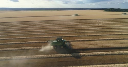 Aerial Side View of Combine Harvester on the Wheat Field