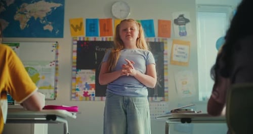 Smart Primary School Girl Showcasing Knowledge of Ecology in Front of Class and Teacher