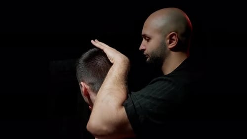 Man Massaging Another Man's Head and Shoulders
