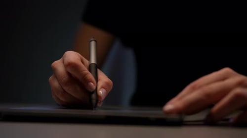 Woman's Hands Drawing on Digital Tablet with Pen