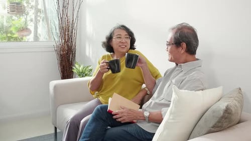Senior Couple Relaxing, Reading and Drinking Coffee