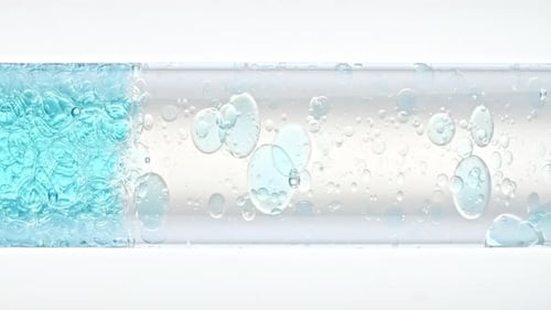 Close Up Transparent Blue Air Bubbles in Clear Water Rising Up in Glass Test Tube on White