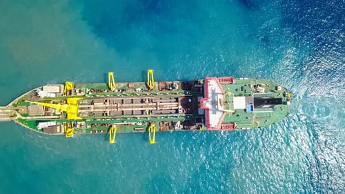 Trailing Suction Hopper-Dredger ship roaring across the sea