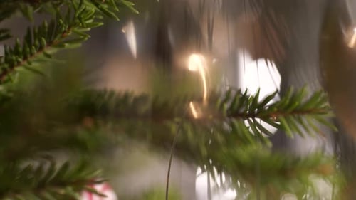 Tree decorations and red bauble with dedication for baby first Christmas. Close up