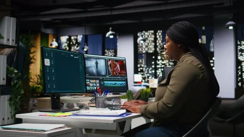 Woman Working on Computer in Modern Office at Night