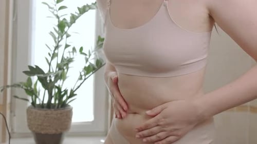 A woman suffers from stomach pain, indigestion, diarrhea, or food poisoning. Symptoms of gastritis,