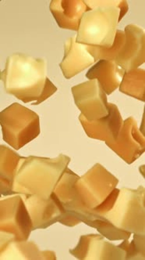 Cubes of Maasdam Cheese Fly on a Light Background Filmed on a Highspeed Camera at 1000 Fps