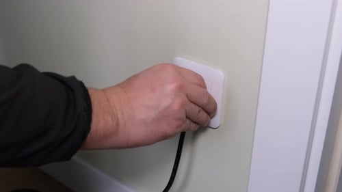 Plugging a Black Power Cord Into White Outlet