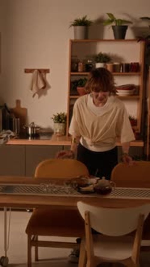 Young Adults Setting Up Table for Meal Indoors