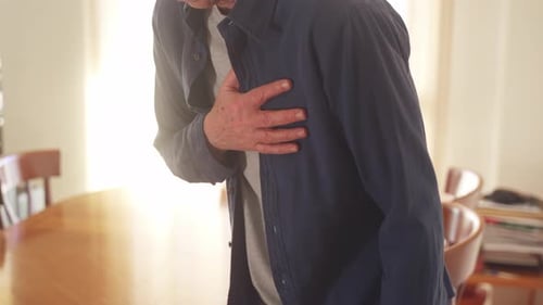 Close up of woman giving first aid to male having heart attack