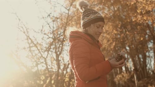 Happy and cheerful woman play with autumn leaves in outdoor leisure activity at the park