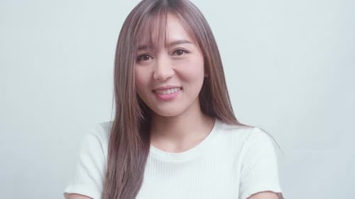 Portrait of young beautiful woman smiling over white background studio