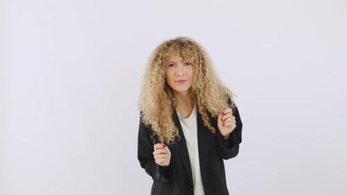 Excited Woman with Curly Hair Celebrates Success