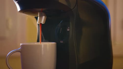 Pouring Coffee Stream From Machine in Cup