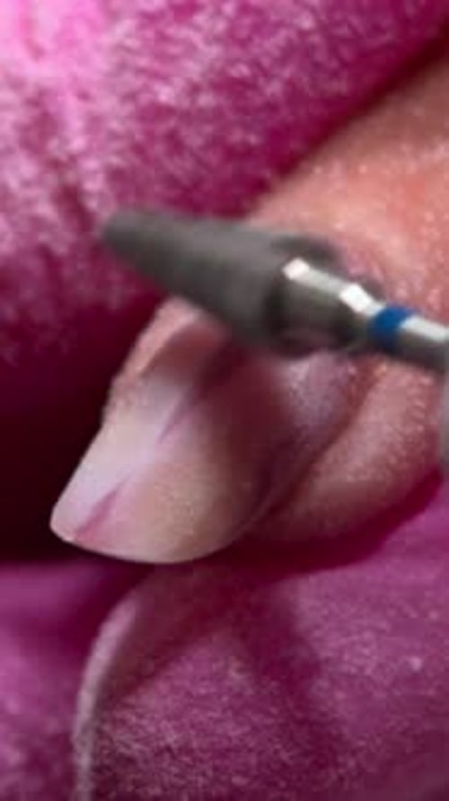 Closeup Buffing Process Technician Meticulously Smooths Nail With Steady Grip And Tiny Particle