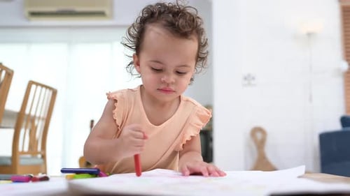 Cute Child Drawing With Crayons at Home