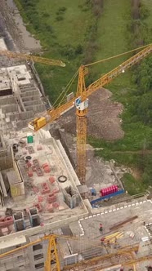 Vertical of Aerial Shot of Crane Construction New Modern Building Work Builders and Technicals