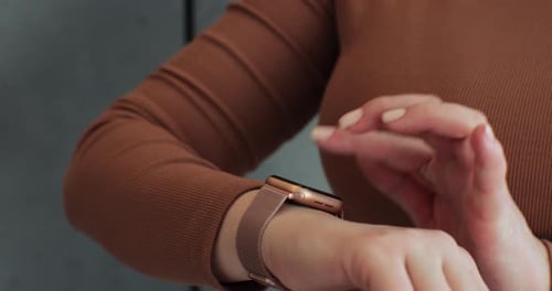 Woman Taps her Smart Watch Screen