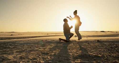 Happy couple, beach and sunset proposal with yes, excited and jump for date
