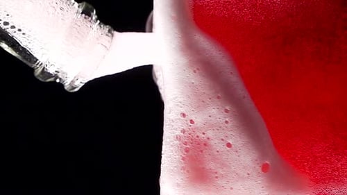 Super Slow Motion of Clean Wine Glass with Champagne Bubbles Texture Filled with Dry Rose Wine