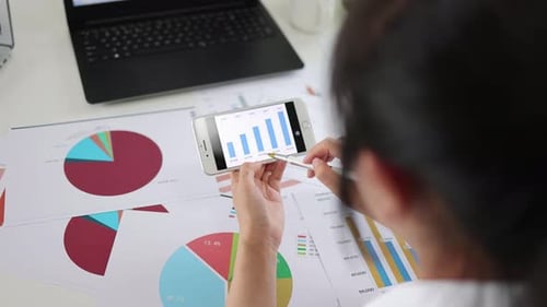 Financial Manager Studying Company Performance Data Chart