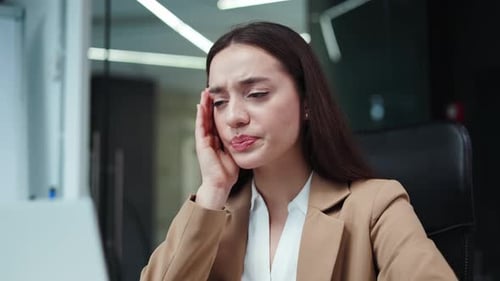 Female Office Worker Using Modern Laptop and Having Headache at Workplace