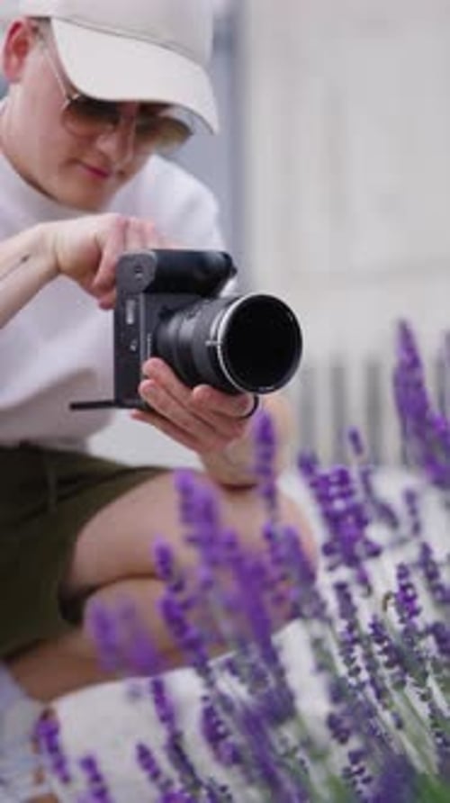 Photographer taking a photo of purple lavender in city